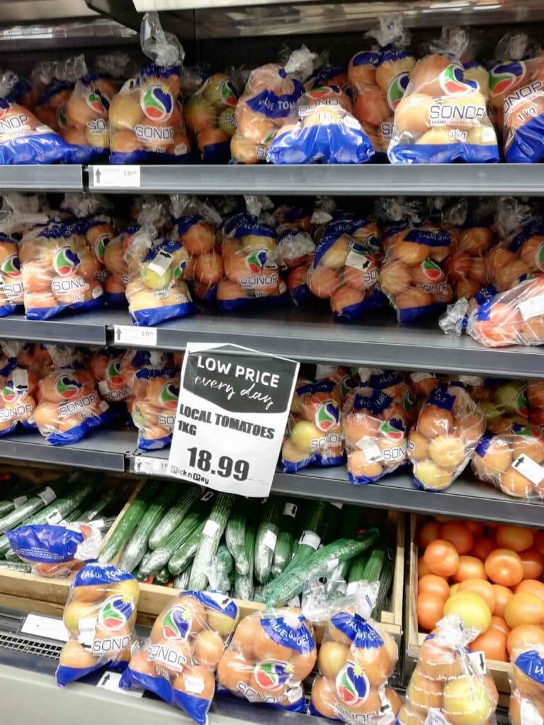 A shelve in a supermarket with bread and vegetables