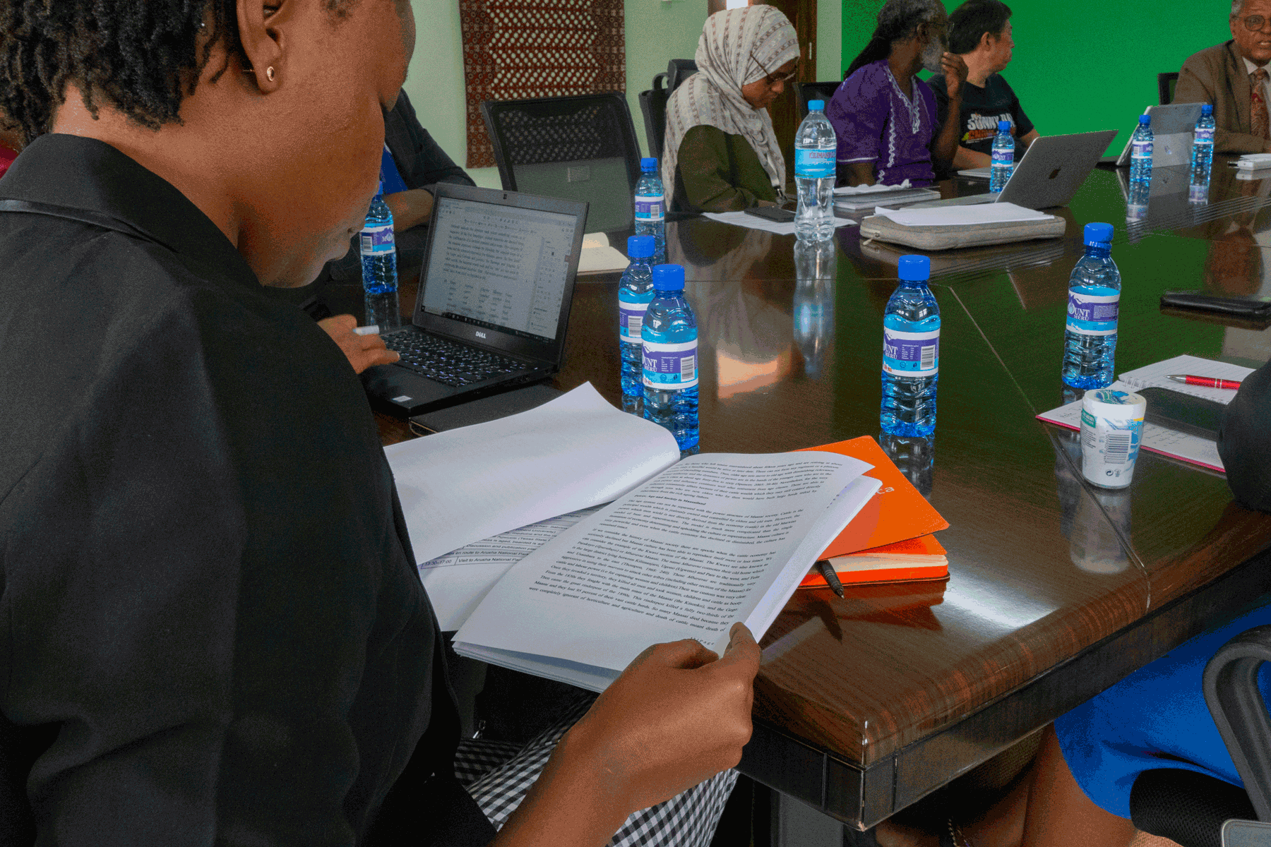 Image of a woman reading an academic paper during a workshop