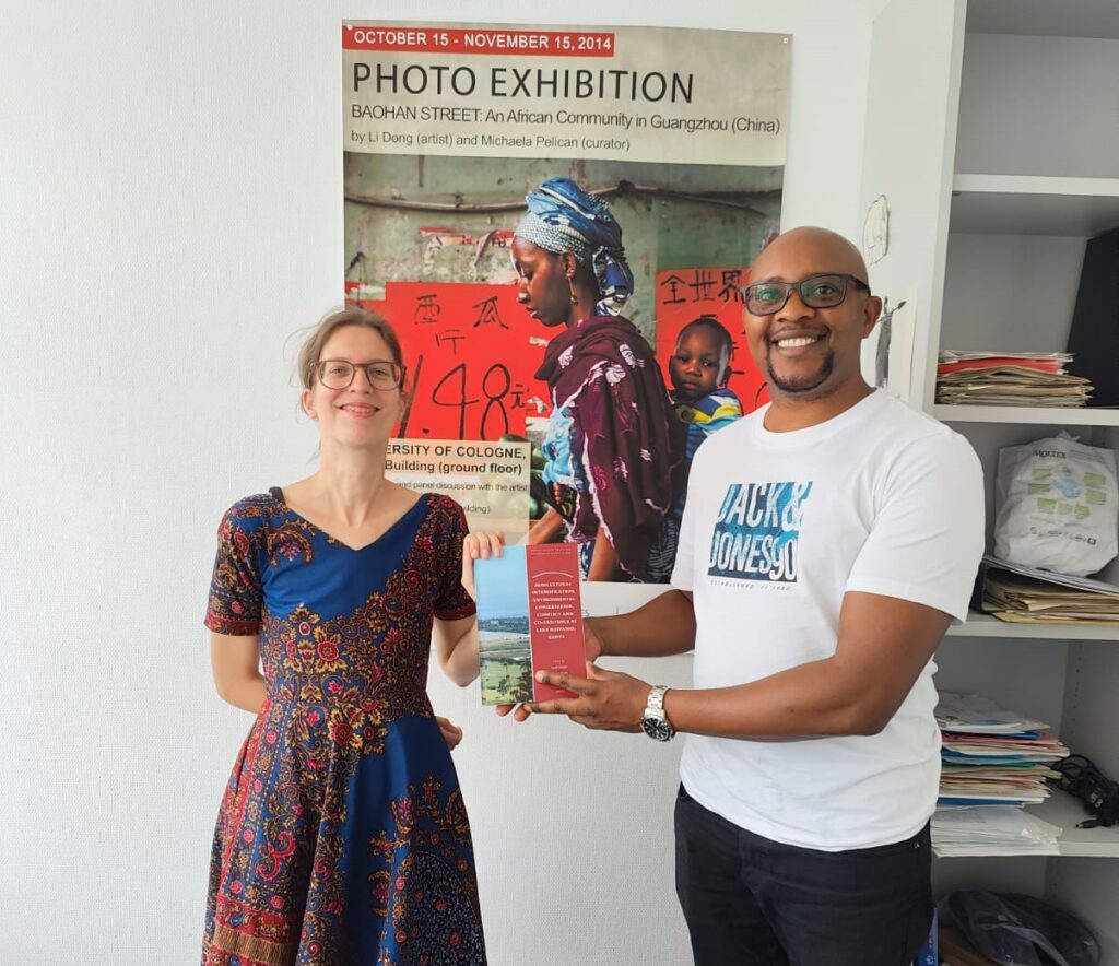 Gerda Kuiper and Eric Kioko holding their newly published book