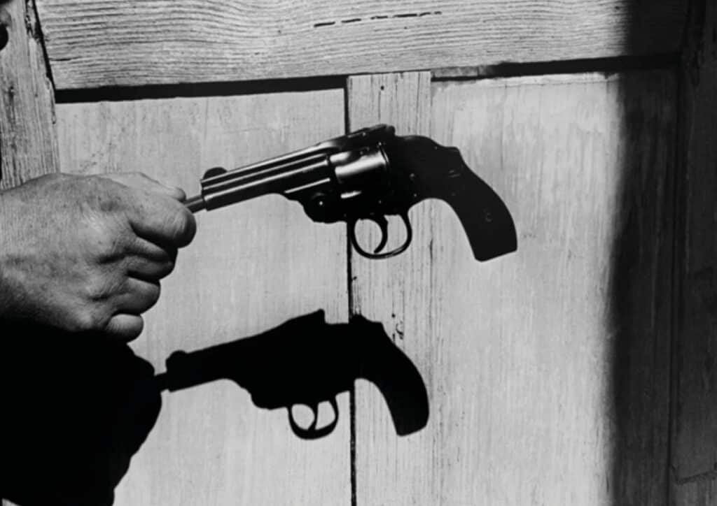 black and white picture of a hand holding a gun