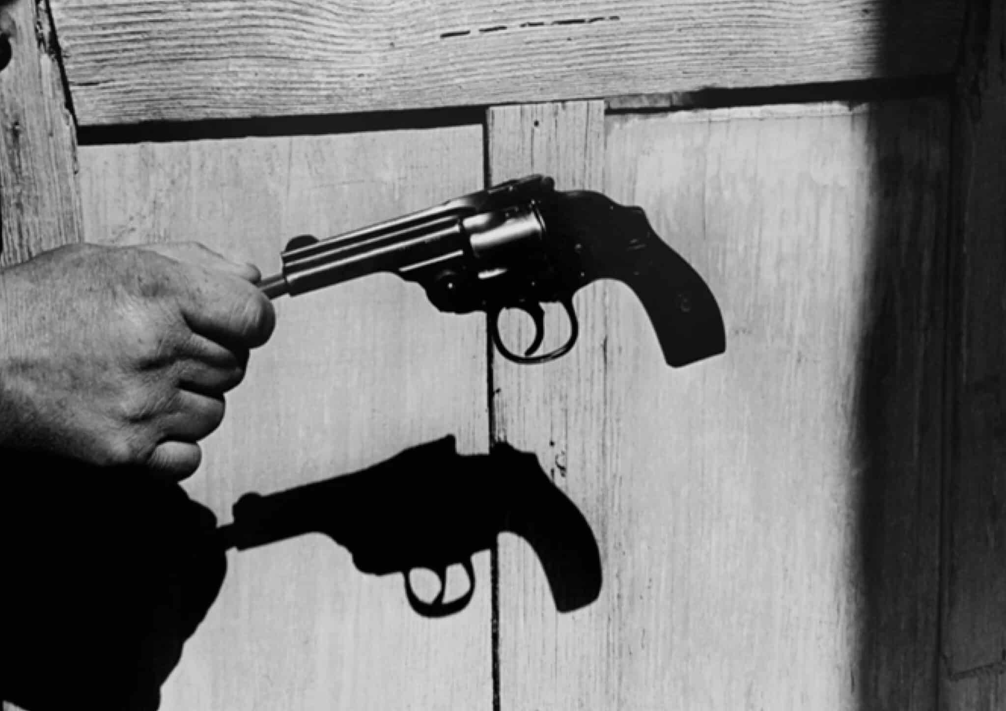 black and white picture of a hand holding a gun