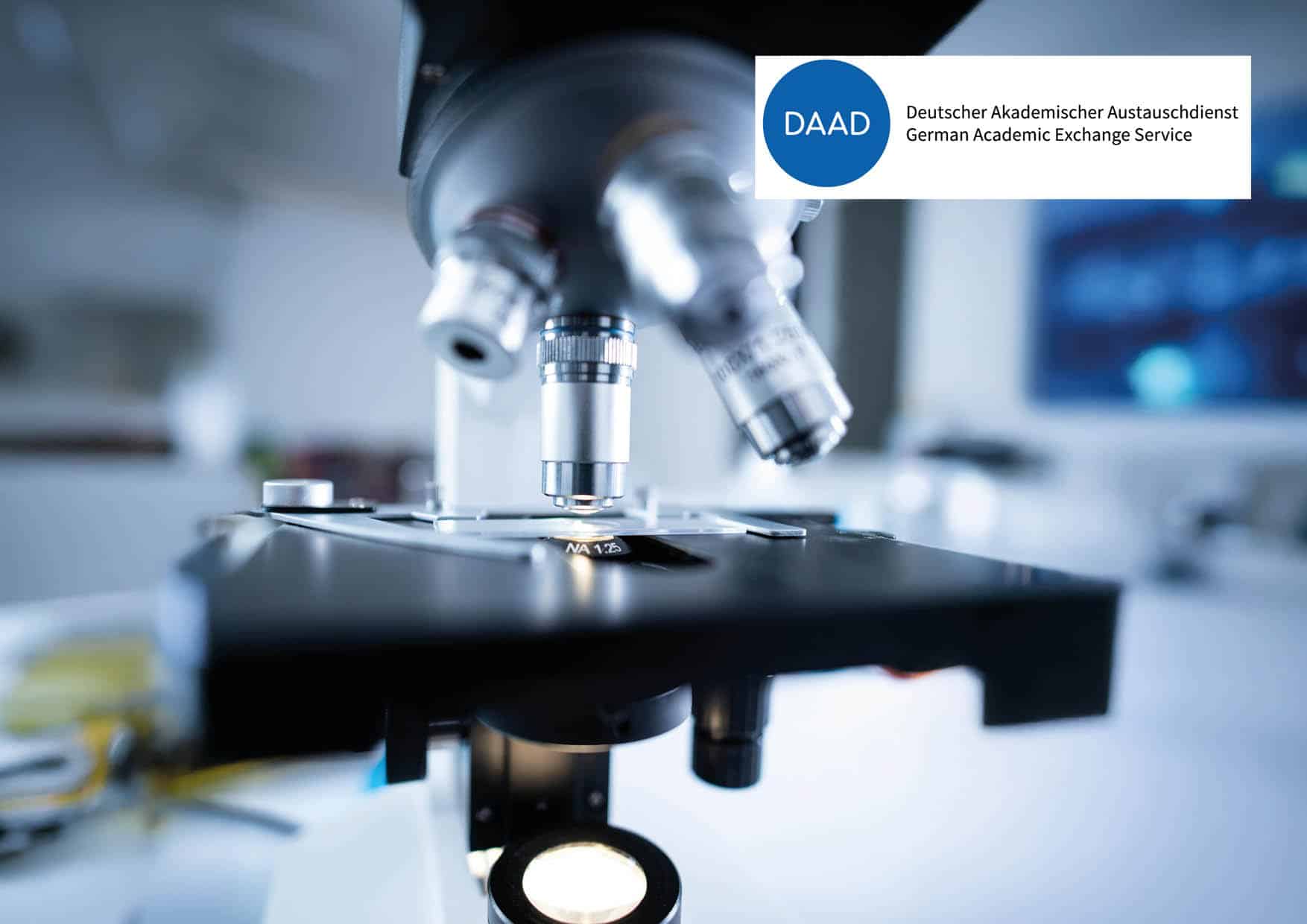 close up of a microscope and the daad logo
