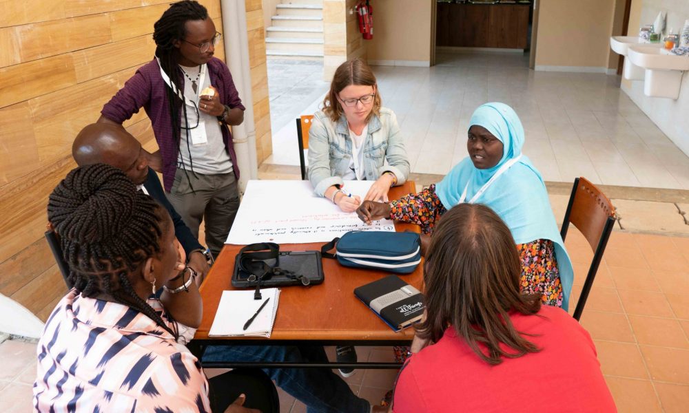 group of people sitting around a desk